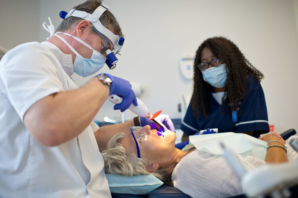 Dr Mark Osmond treating a patient with his dental nurse